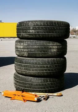 Four wheels standing on top of each other for seasonal re-shoeing of a car wi Stock Photos