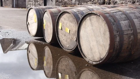 Four Whiskey Casks Outside Scottish Distillery with Reflection in Pool of Water 스톡 동영상 97615693