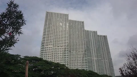Four white buildings with blue windows stand elegantly in Bekasi city indonesia Stock Footage 269541920