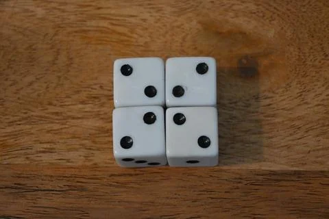 Four white dice showing two Stock-Fotos