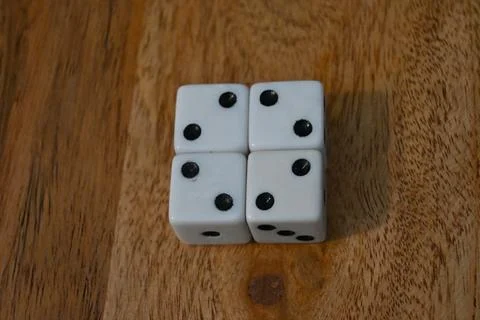 Four white dice showing two pips Stockfoto's