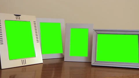 Four White Picture Frames With Green Screen on Shelf in Living Room - Close Up Stock Footage 311483630