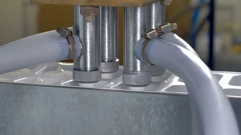 Four wide nozzles fill plastic containers with sour cream. Stock Footage