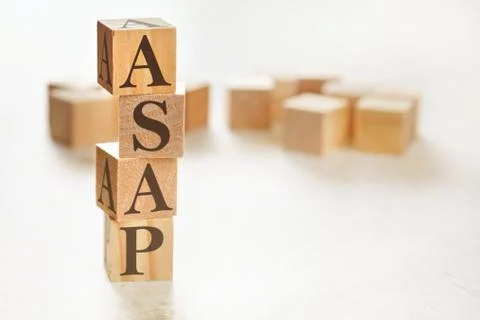 Four wooden cubes arranged in stack with text ASAP meaning As Soon As Possible 스톡 사진