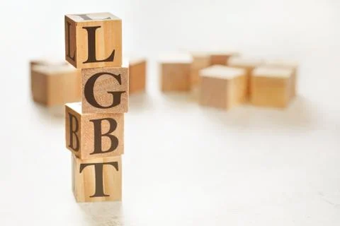 Four wooden cubes arranged in stack with text LGBT on them, space for text image Stock Photos