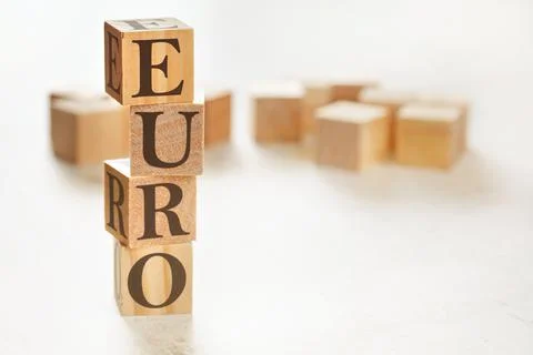 Four wooden cubes arranged in stack with word EURO on them, space for text /  Stockfoto's