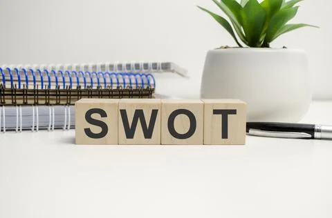 Four wooden cubes arranged in stack with text SWOT 스톡 사진