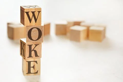 Four wooden cubes arranged in stack with word WOKE (stands for Wisdom Opportu 스톡 사진