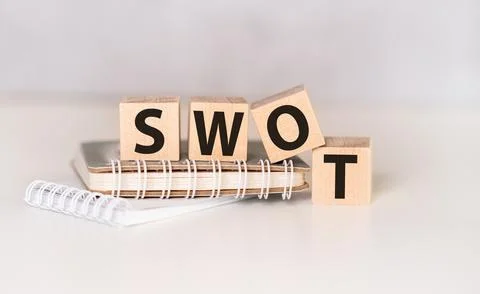 Four wooden cubes arranged in stack with text SWOT (meaning Strengths, Weak.. Stock Photos