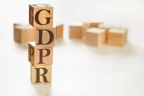 Four wooden cubes arranged in stack with letters GDPR meaning General Data... Foto stock
