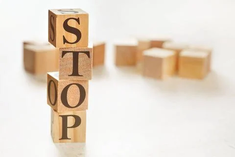 Four wooden cubes arranged in stack with word STOP on them, space for text... 스톡 사진
