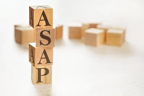 Four wooden cubes arranged in stack with text ASAP meaning As Soon As Poss... Stockfoto's
