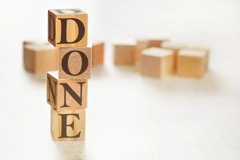Four wooden cubes arranged in stack with word DONE on them, space for text... 스톡 사진