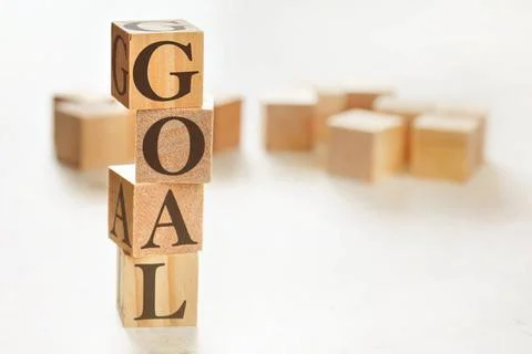 Four wooden cubes arranged in stack with word GOAL on them, space for text... Stock Photos