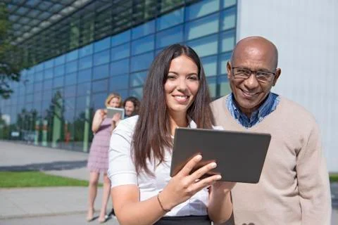 Four work colleagues multicultural tablet computer Stock Photos