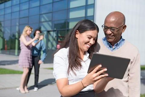 Four work colleagues multicultural tablet computer Stock Photos