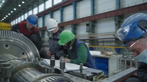 The four workers are getting ready for continuing production of the turbine part Stock Footage 220684879