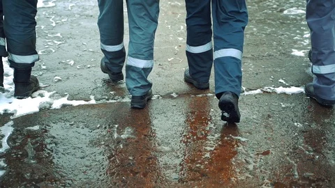 Four workers in a gray uniform with a horizontal white stripe on their pants Video stock 104081989