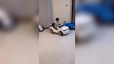 Four-year-old boy shows off incredible parallel parking skills with toy car in Stock Footage 272976037
