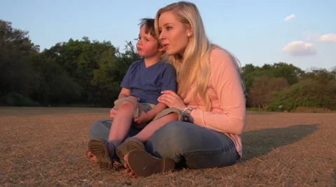 Four year old boy sitting on mothers lap and interacting Stock Footage 46375837