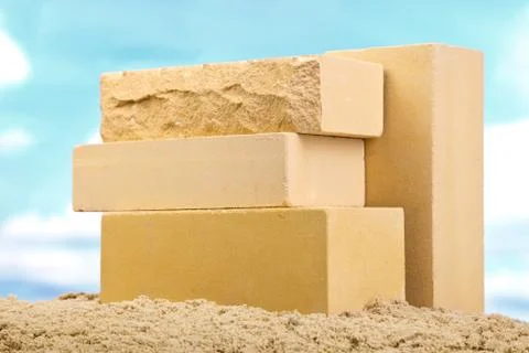 Four yellow ceramic bricks on the sand at the blue sky background Stock Photos