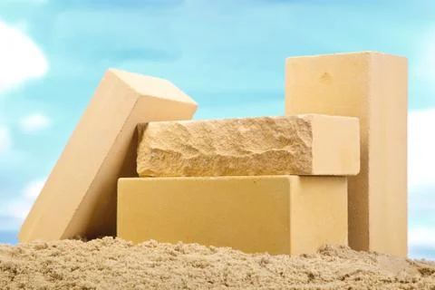 Four yellow ceramic bricks on the sand at the blue sky background Stock Photos