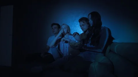 Four young charming friends two girls and two guys eat popcorn Stock Footage 116175451