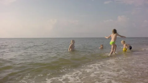 Four young children playing on the beach balls. Stock Footage 64669089