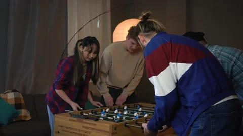 Four Young Colleagues Playing Table Soccer at Office Party Stock Footage 150290229