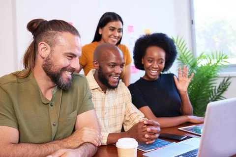Four young members of tech start up join video call, group meeting, smiling Stock Photos