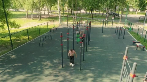 Four young men are doing bodyweight exercise outdoors Stock Footage 92310527
