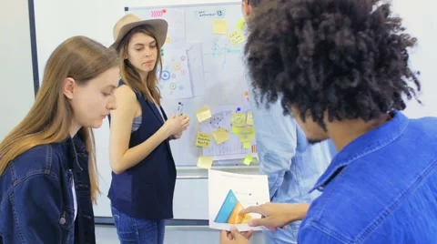 Four young people work on very important project Stock Footage 60787743