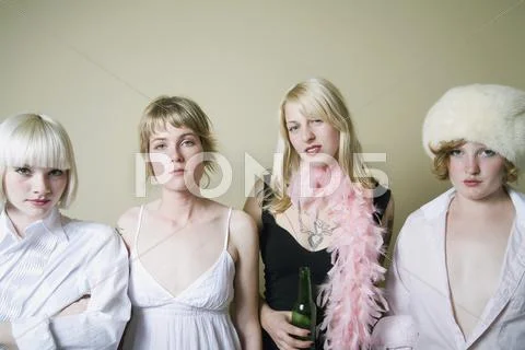Four young women standing in a row Stock Photos