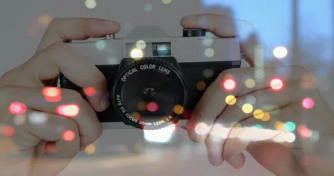 At fourth second hands gripping film camera adjusting focus ring and shutter Stock Footage 314174665