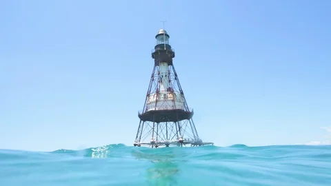 Fowey Rocks Lighthouse in middle of the turquoise sea Stock Footage 116346394