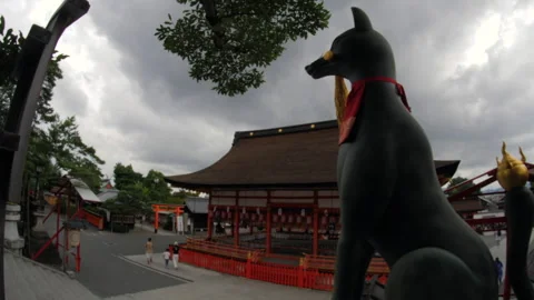Fox Statue and Shrine Courtyard Under Dramatic Clouds in Kyoto, Japan Stock Footage 341527454