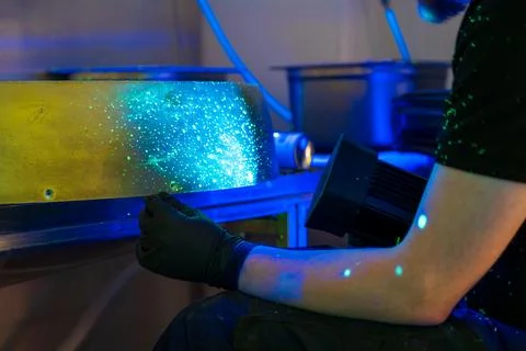 FPI testing showing fluorescent indications under blacklight examination Stock Photos