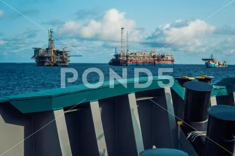 Fpso Tanker Vessel Near Oil Rig Platform. Offshore Oil And Gas Industry
