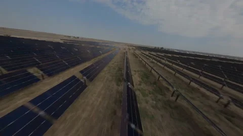 FPV aerial flying low over solar arrays in solar field Stock Footage 166187206
