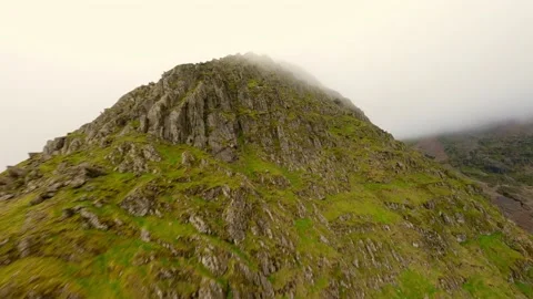 FPV Aerial view of snowdon summit in the distance covered in fog leading into Stock Footage 197492555