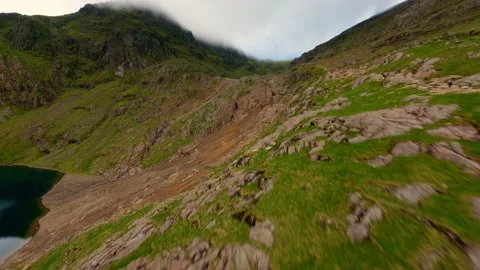 FPV Aerial view of snowdon summit in the distance covered in fog leading into Stock Footage 197493435