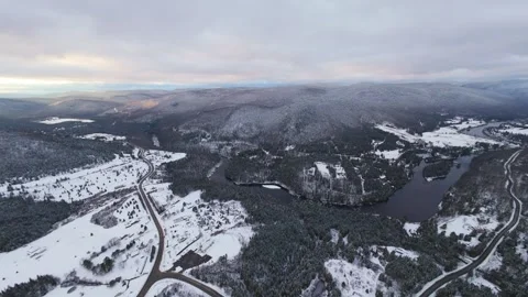 Fpv ascent over forested snowy ridge Stock Footage 321178780