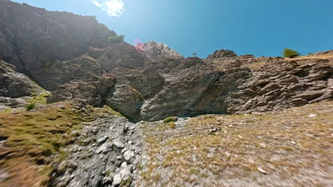 FPV Ascent Through Steep Dry Gully on Rugged Mountain Slope Stock Footage 346113301
