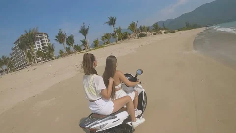 Fpv camera flies after two girls on a motorcycle Video stock 237731274