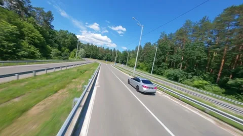 FPV, The car goes on the road. Mixed forest. Road Trip, business car Stock Footage 262007022