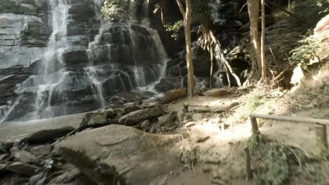 FPV Close-Up Flight Over Rocks and Waterfalls  Tat Mok Stock Footage 332794466
