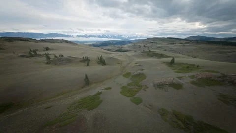 The FPV copter flies fast at low altitude over the hills. Cloudy evening weather Stock Footage 278367809