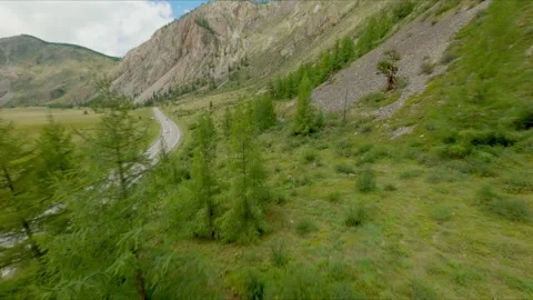 The FPV copter flies at high speed close to the rock rock. Excellent views of Stock Footage 278369098
