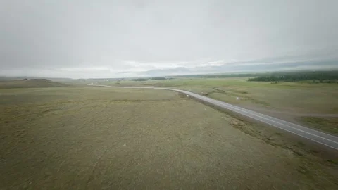 The FPV copter flies low to the ground. Shooting early in the morning at dawn in Stock Footage 278368702