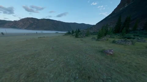 The FPV copter flies low to the ground. Shooting early in the morning at dawn in Video stock 278369114